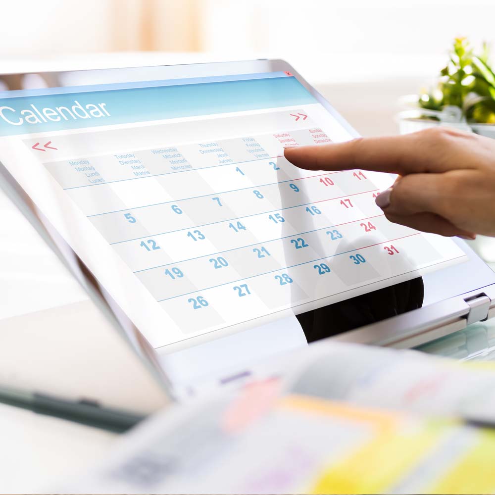 Computer repair appointments, book onnline now. Photo of a person using a notebook/tablet to make a booking.